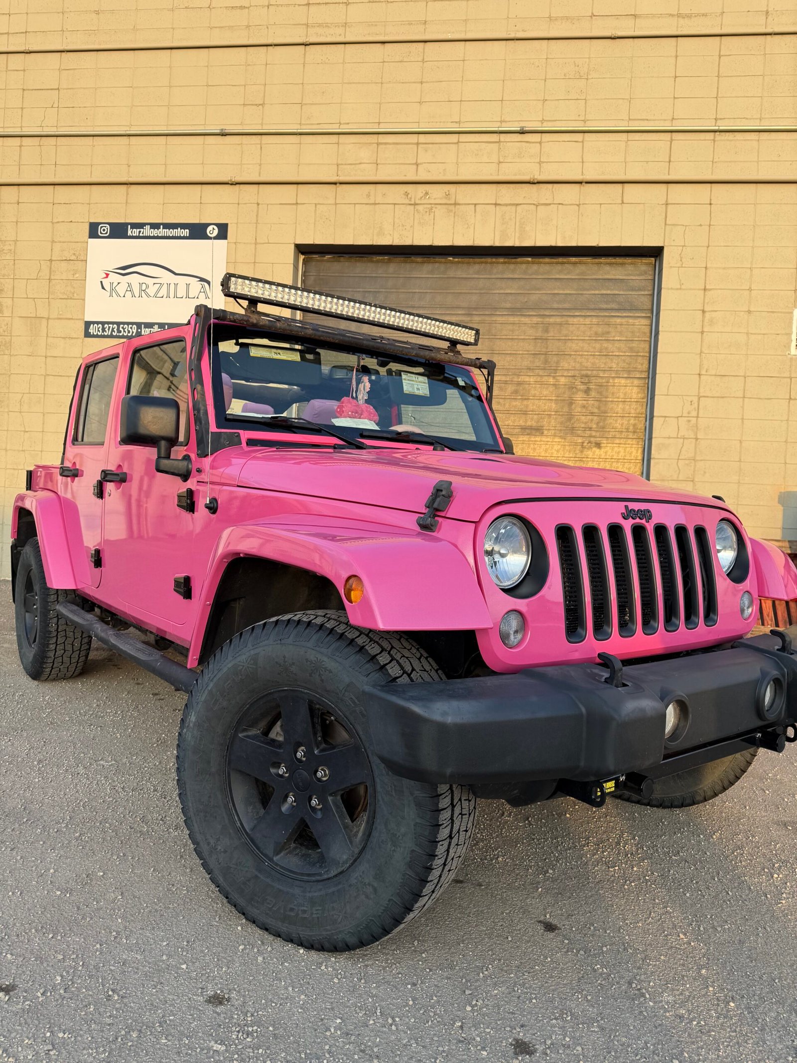 a pink jeep that had a vinyl car wrap done by Karzilla in Edmonton
