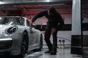man washing car before ceramic coat