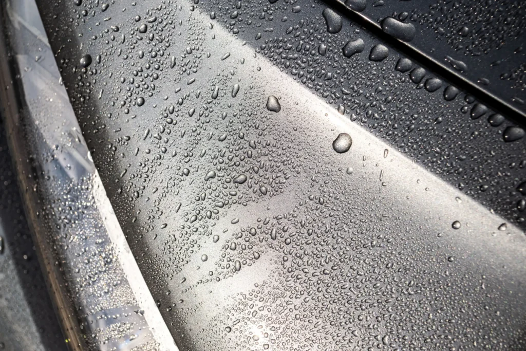 Edmonton technician applying ceramic coating on a vinyl-wrapped car for added protection and gloss