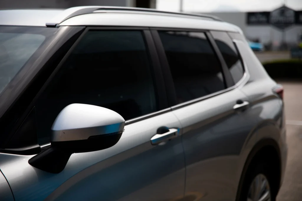 Cleaning tinted car windows with a microfiber cloth using ammonia free cleaner